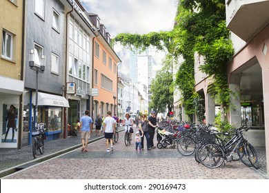 FREIBURG IM BREISGAU, GERMANY - AUGUST 6, 2014: Old town street in Freiburg, a city in the south-western part of Germany in the Baden-Wurttemberg state.