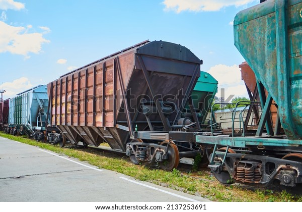 Freight cars are parked and waiting for\
loading with industrial goods. Transportation of various materials\
over long distances.