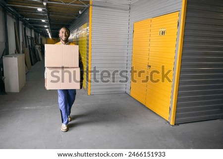 Freight handler posing for camera at work in storage facility