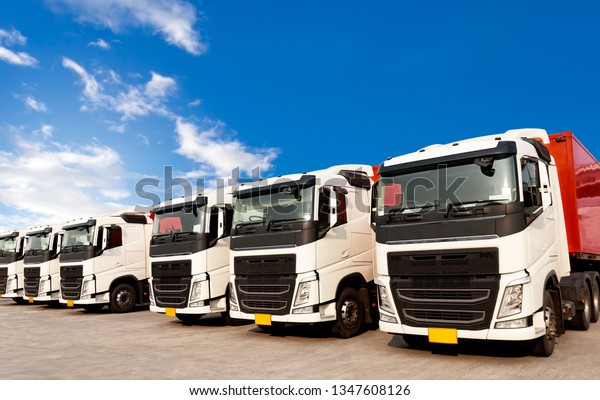 Freight logistics, trucks transportation, lorries\
parked with a blue sky.
