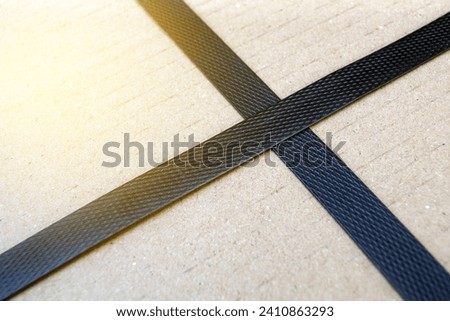 freight parcel with plastic black strap background.