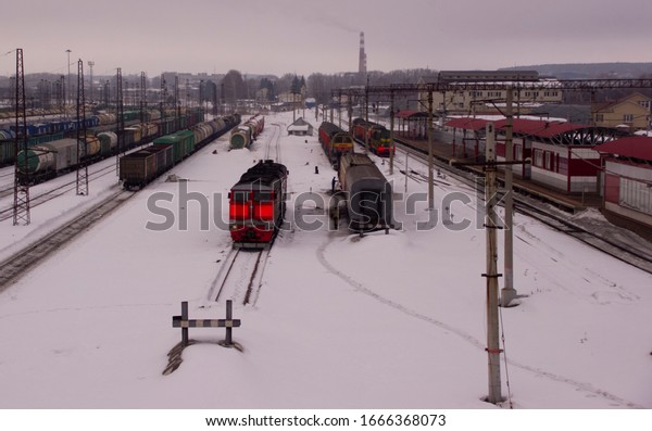 Freight railway cars at the\
railway station. Top view of cargo trains.Wagons with goods on\
railroad. Heavy industry. Industrial conceptual scene with\
trains.
