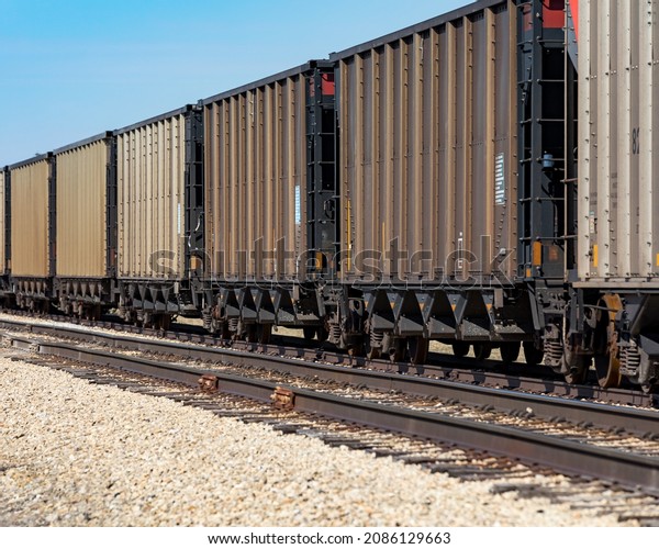 Freight train cars on railroad\
tracks. Supply chain, rail transportation and shipping\
concept