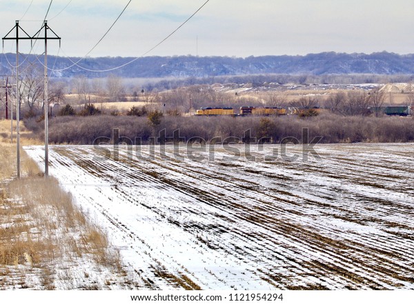 A freight train\
crosses the winter valley.