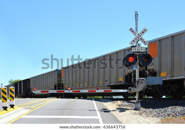 Freight train at crossing\
gate
