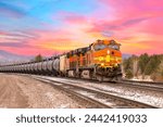 freight train in early springtime with beautiful sunset in the background close to Whitefish, Montana