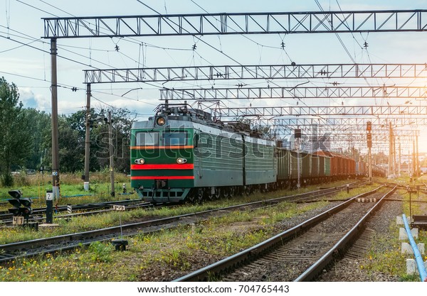 Freight train
green with cargo cars on the
railway