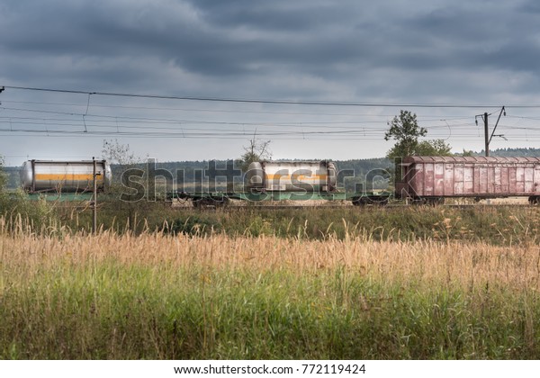 Freight train and a green\
field.