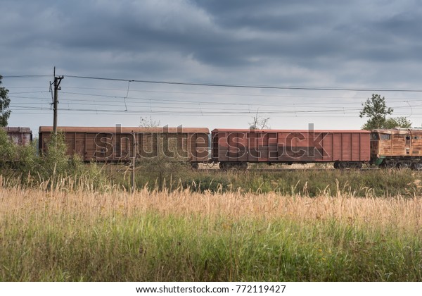 Freight train and a green
field.
