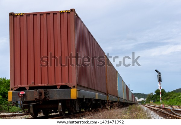 freight train loaded with shipping containers,\
Cargo train platform