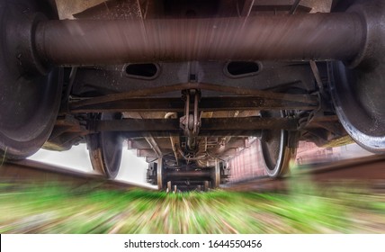 Freight train in motion. View under the train. Blurred background gives a feeling of movement.