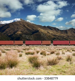 Freight Train In A Mountain Landscape