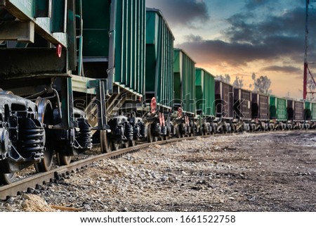The freight train passes by the station. Wagons with goods delivery.
