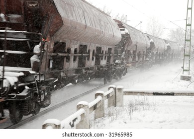 Freight Train Passing By In The Snow With Motion Blur