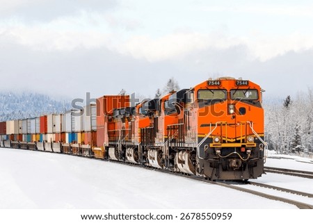 freight train pulling cargo in winter close to Whitefish, Montana