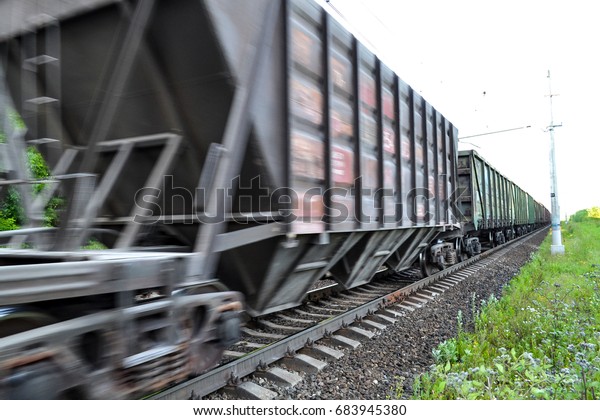 Freight train, railway wagons with motion blur\
effect. Transportation,\
railroad.
