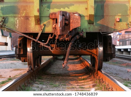 Freight train. Rear view of the last wagon of a freight train at a railway station at sunset. Close-up.