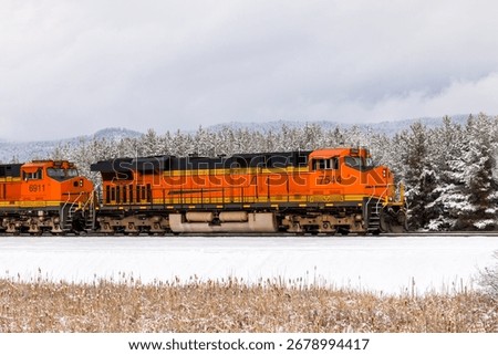 freight train in winter pulling cargo near Whitefish, Montana