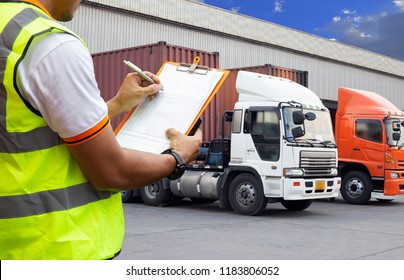 Freight transportation. warehouse worker are holding clipboard with control loading a trucks.