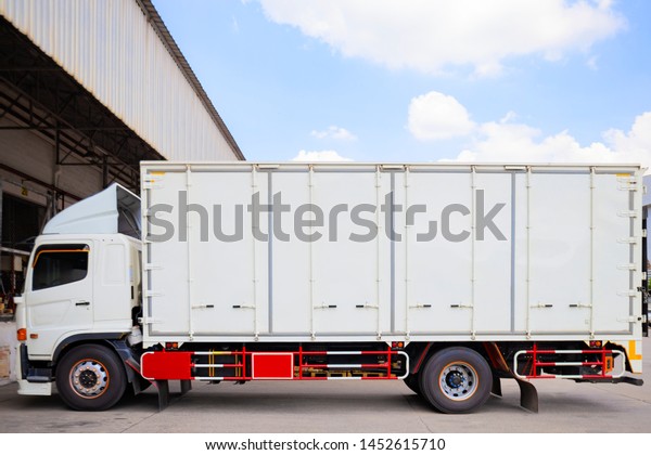 freight\
transportation. white truck parking at\
warehouse.