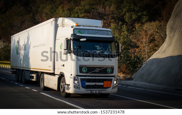 Freight\
truck on a beautiful mountain road. This is a Volvo truck.\
Location: Romania, Orsova. October, 20,\
2019