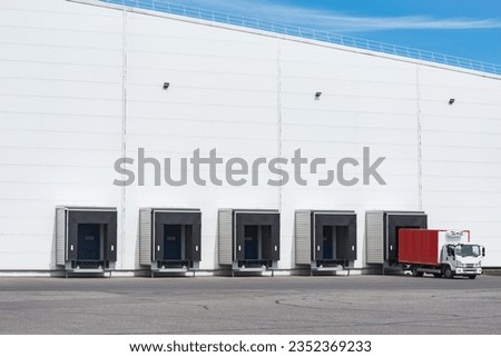 Freight truck stands by the door of the storage.