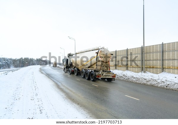 Freight truck with tank,\
semi truck, tractor unit and semi-trailer to carry freight. Cargo\
transportation in harsh winter conditions on slippery, icy and\
snowy roads.