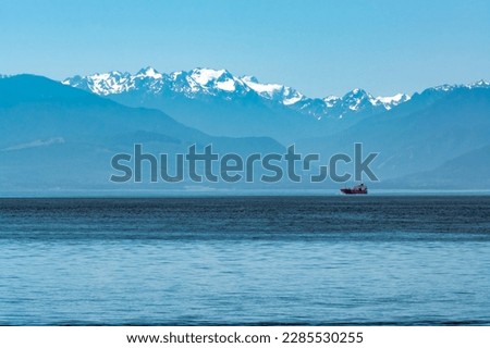 Freight vessel going over the bay on Pacific ocean at Vancouver island