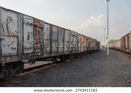 Freight wagons showing rust and decay on a track in an industrial setting