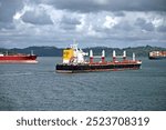 Freighters on Gatun Lake the middle of Panama Canal crossing heading to Gatun Locks at the Atlantic side.