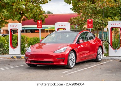 Fremont, CA, USA - October 30, 2021: Red Tesla at the charging station. 