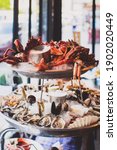 French 2 tiers seafood platter with dry ice on top and smoke coming down. Seafood including Tasmanian giant crab, raw oysters, scallop, shrimps, king prawns and mussels.