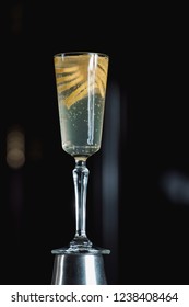 French 75 Alcoholic Cocktail Garnish With A Long Ribbon Of Lemon Peel