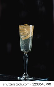 French 75 Alcoholic Cocktail Garnish With A Long Ribbon Of Lemon Peel