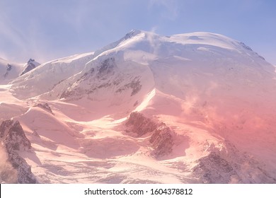 French Alps, Europe Sunset Snow Mountains Landscape Background. Colorful Pink And Blue