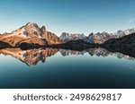 French alps landscape of Lac Blanc with Mont Blanc massif and mountain goat walking reflected on lake in the sunset at Haute Savoie, Chamonix, France