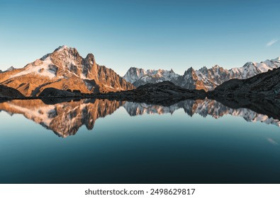 French alps landscape of Lac Blanc with Mont Blanc massif and mountain goat walking reflected on lake in the sunset at Haute Savoie, Chamonix, France