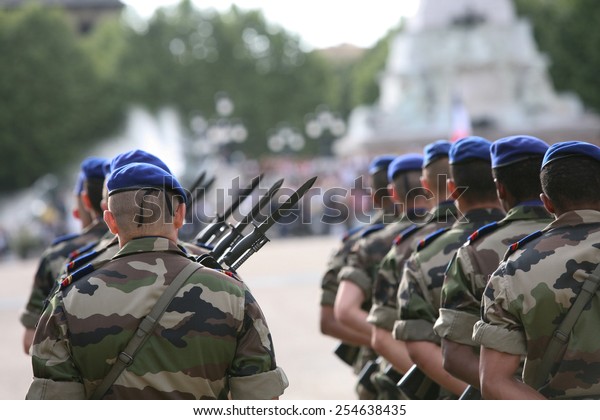 A french armed marching\
soldier
