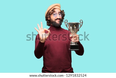 French artist with a beret holding a trophy