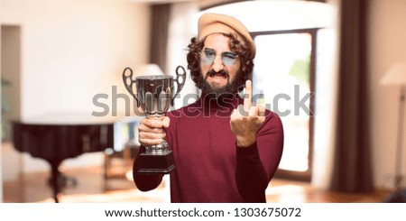 French artist with a beret holding a trophy