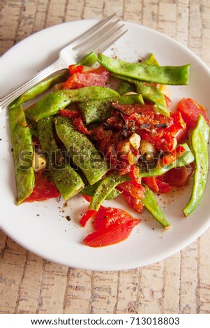 french beans served with tomato and garlic
