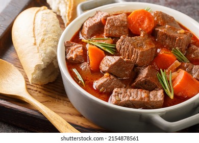 French beef stew in red wine known as daube de boeuf Provencal closeup in the wooden tray on the table. Horizontal
