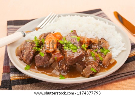 French beef stew in red wine, on a plate with rice. Known as daube de boeuf Provencal.
