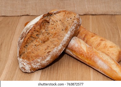 French black bread, loaf and ciabatta on a wooden background