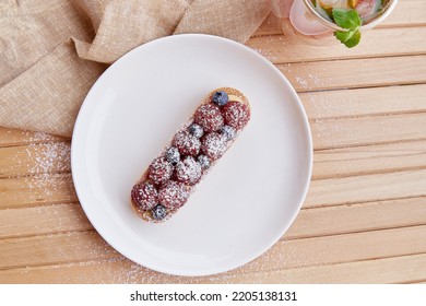 French Blueberry And Raspberry Tart On White Ceramic Plate. Top View Food. Aesthetic Food.