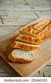 French Bread Baguette Cut On Wooden Board
