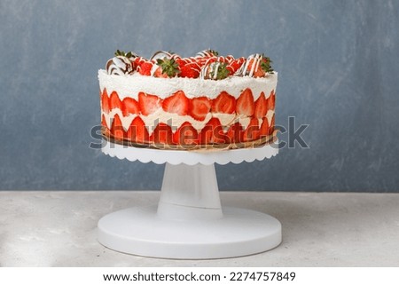 French Cake Fraisier With Fresh Strawberries And Raspberies On Turntable, Grey Background. Side View. Copy Space.