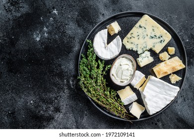 French Cheese plate. Camembert, Brie, Gorgonzola and blue cream cheese. Black background. Top view. Copy space - Powered by Shutterstock