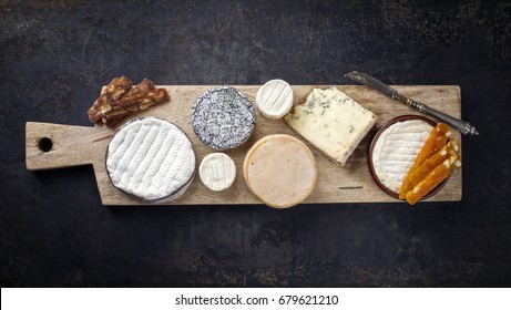 French Cheese Platter With Spanish Dulce De Membrillo As Top View On A Wooden Board