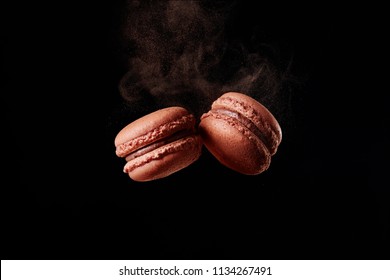 French Chocolate Macaron With Cocoa Powder Against Black Background